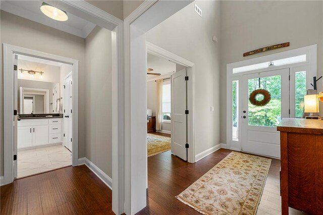 entryway featuring ornamental molding and dark hardwood / wood-style flooring