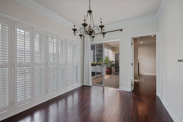 175 15th St NE Unit 410, Atlanta, GA 30309 - unfurnished dining area featuring a chandelier, ornamental molding, hardwood / wood-style floors, and baseboards