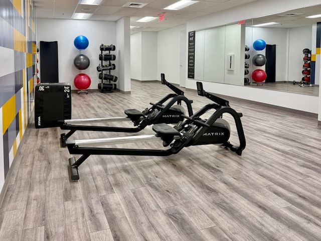 175 15th St NE Unit 410, Atlanta, GA 30309 - gym featuring a drop ceiling, wood finished floors, and baseboards