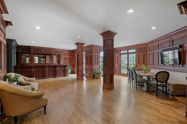 175 15th St NE Unit 410, Atlanta, GA 30309 - living area with ornate columns, a decorative wall, recessed lighting, and light wood-style floors