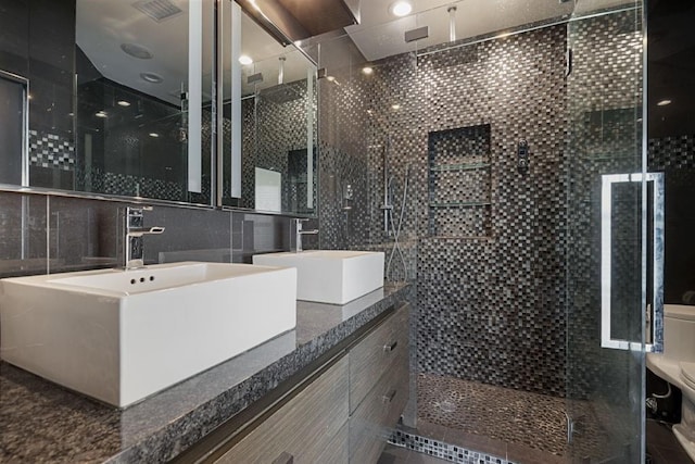 175 15th St NE Unit 410, Atlanta, GA 30309 - full bath featuring a shower stall, double vanity, and tile walls