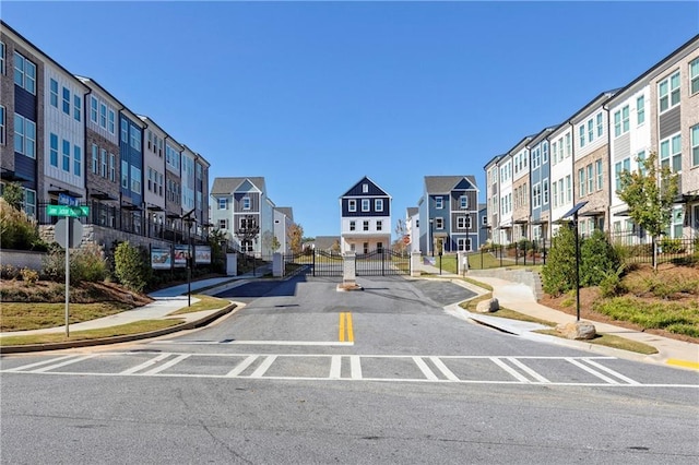 view of street featuring sidewalks, a residential view, traffic signs, and curbs