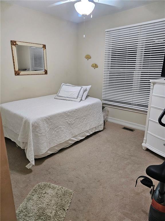 carpeted bedroom featuring ceiling fan