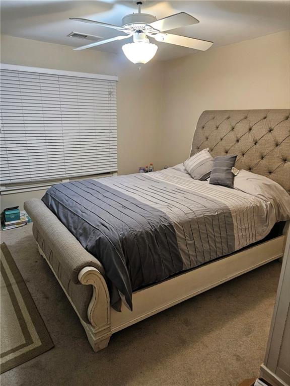 carpeted bedroom featuring ceiling fan