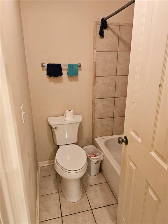 bathroom with tile patterned floors and toilet