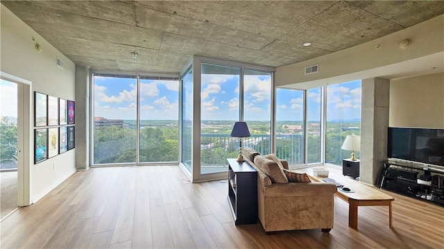 3300 Windy Ridge Parkway SE Unit 1121, Atlanta, GA 30339 - living area featuring wood finished floors and floor to ceiling windows