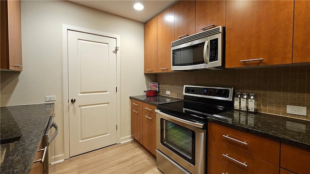 3300 Windy Ridge Parkway SE Unit 1121, Atlanta, GA 30339 - kitchen with stainless steel appliances, light wood-style floors, brown cabinets, and recessed lighting