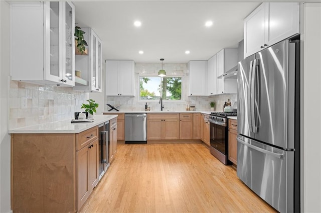1494 May Ave SE, Atlanta, GA 30316 - kitchen with appliances with stainless steel finishes, light wood finished floors, light countertops, glass insert cabinets, and recessed lighting