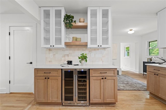 1494 May Ave SE, Atlanta, GA 30316 - bar area featuring beverage cooler, light wood finished floors, decorative backsplash, and baseboards