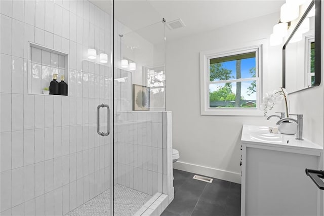 1494 May Ave SE, Atlanta, GA 30316 - bathroom with double vanity, toilet, a stall shower, baseboards, and tile patterned flooring