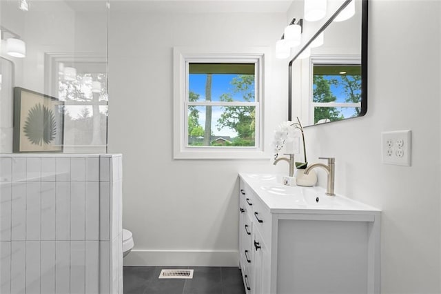 1494 May Ave SE, Atlanta, GA 30316 - bathroom with tile patterned floors, double vanity, toilet, and baseboards