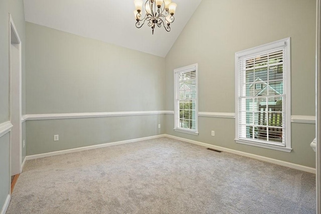 carpeted spare room featuring high vaulted ceiling, visible vents, baseboards, and an inviting chandelier