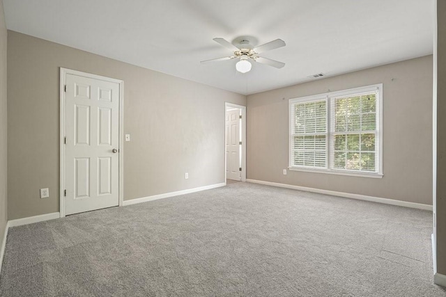 spare room featuring carpet flooring and baseboards