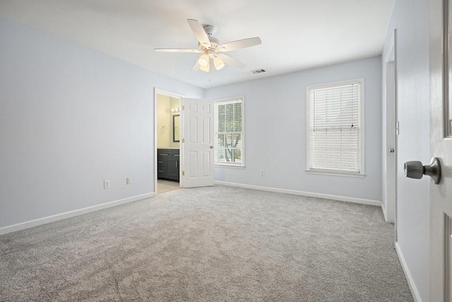 unfurnished bedroom featuring light carpet, visible vents, and baseboards