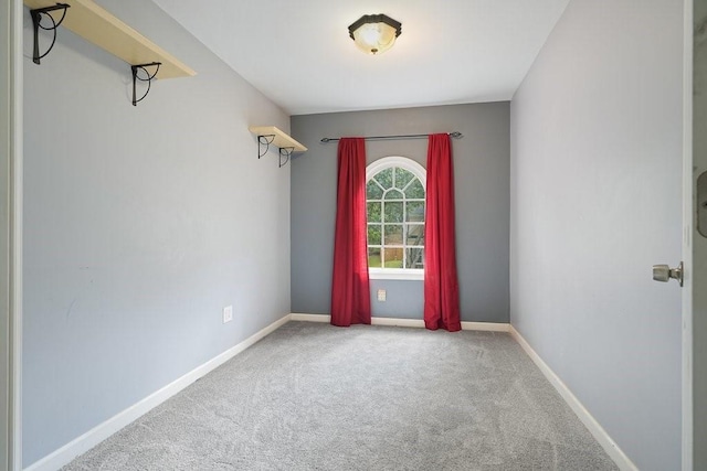 empty room with carpet and baseboards