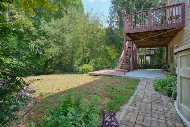 view of yard with a deck, a patio area, and stairway