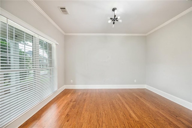 5635 Upper Creek Ct, Suwanee, GA 30024 - spare room with a chandelier, wood finished floors, baseboards, and ornamental molding