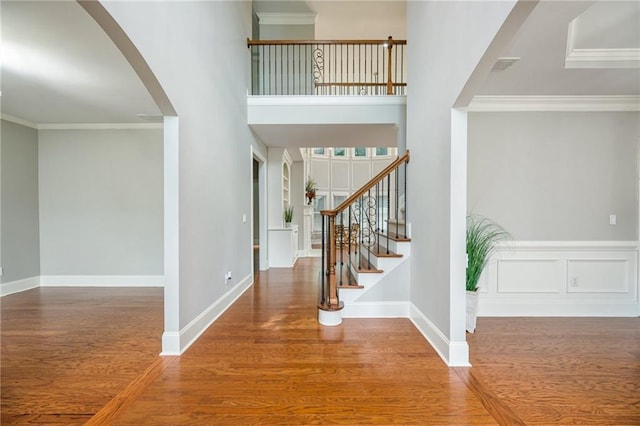 5635 Upper Creek Ct, Suwanee, GA 30024 - entryway featuring wood finished floors, arched walkways, crown molding, stairway, and baseboards