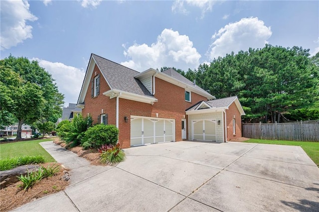 5635 Upper Creek Ct, Suwanee, GA 30024 - view of side of home featuring brick siding, concrete driveway, a garage, and a shingled roof