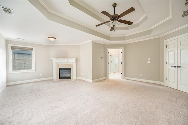 5635 Upper Creek Ct, Suwanee, GA 30024 - unfurnished living room with a tray ceiling, crown molding, light colored carpet, a ceiling fan, and baseboards