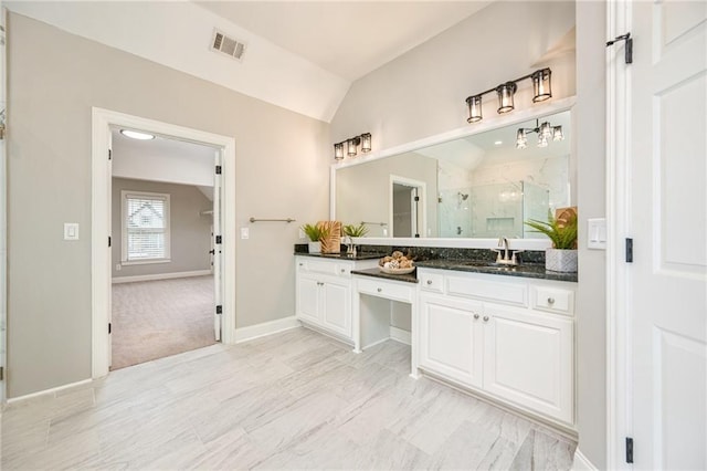5635 Upper Creek Ct, Suwanee, GA 30024 - bathroom with a marble finish shower, double vanity, vaulted ceiling, and baseboards
