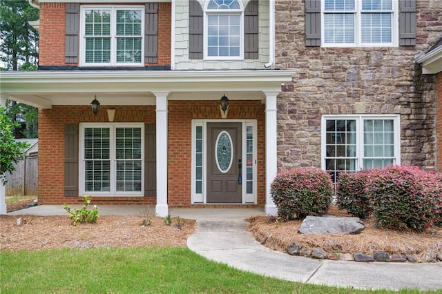 5635 Upper Creek Ct, Suwanee, GA 30024 - doorway to property with stone siding and a porch