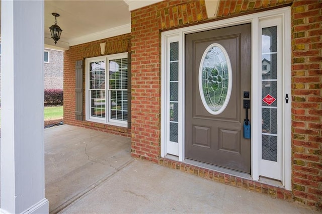 5635 Upper Creek Ct, Suwanee, GA 30024 - view of exterior entry featuring brick siding and a porch