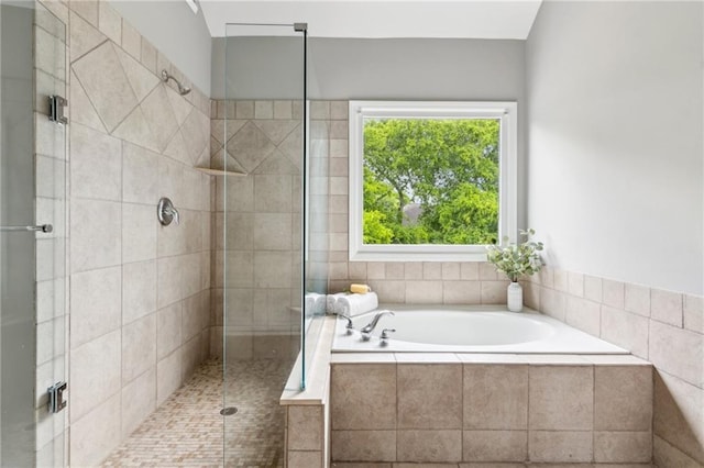 bathroom featuring a garden tub and a stall shower