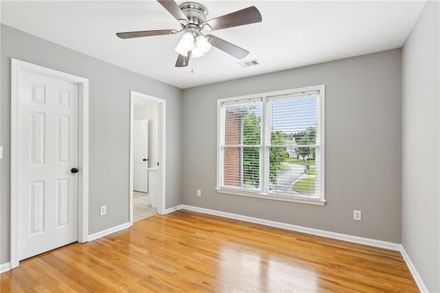 unfurnished bedroom featuring light wood-type flooring, visible vents, and baseboards