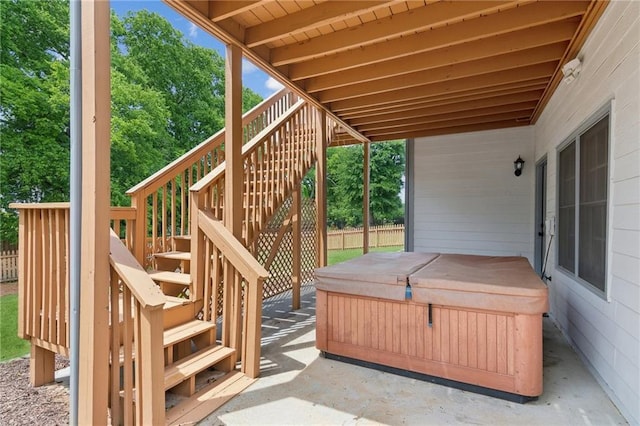 deck with stairway, a patio, a hot tub, and fence