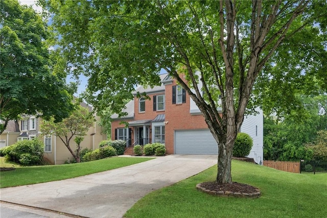 view of front of home featuring a front lawn, driveway, fence, and a garage