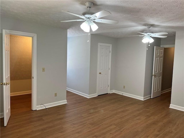 unfurnished room featuring a textured ceiling, dark hardwood / wood-style floors, and ceiling fan