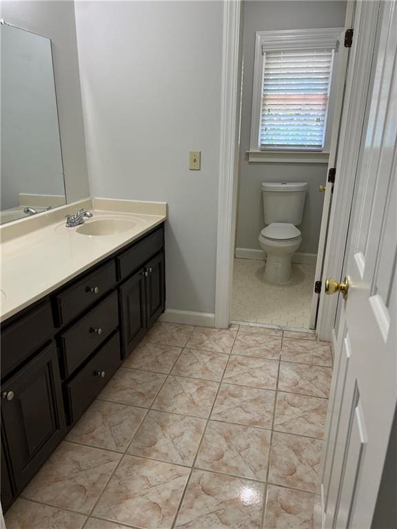 bathroom featuring toilet, vanity, and tile patterned floors