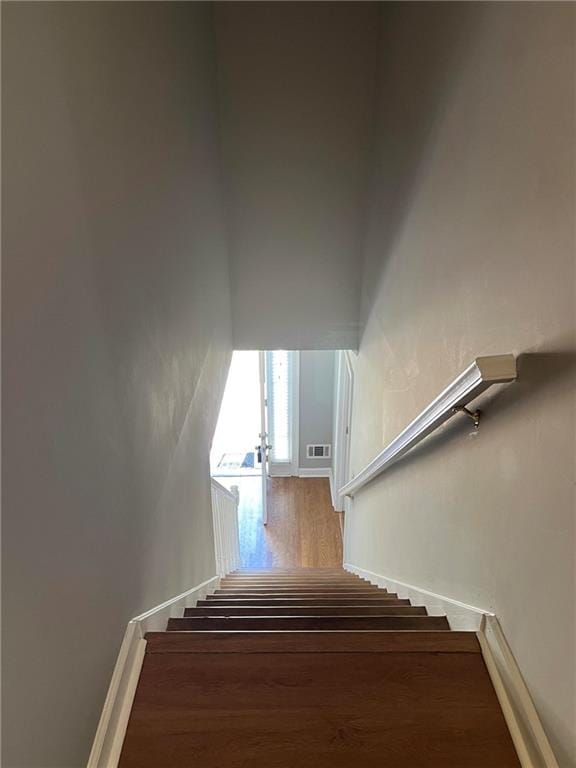 staircase with hardwood / wood-style flooring