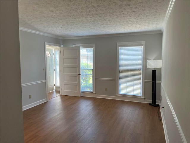 spare room featuring crown molding, a textured ceiling, and dark hardwood / wood-style flooring