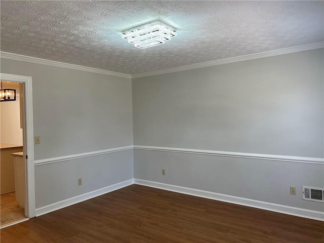 empty room with ornamental molding, dark hardwood / wood-style floors, and a textured ceiling