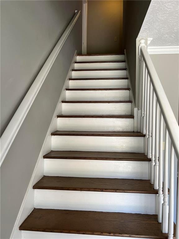 staircase with hardwood / wood-style floors