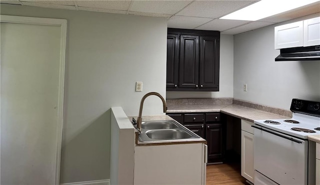 kitchen with white range with electric stovetop, white cabinetry, light hardwood / wood-style floors, a drop ceiling, and sink