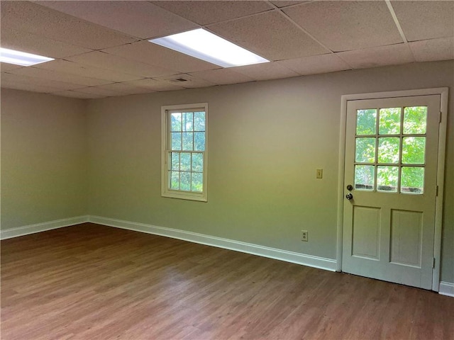 interior space with wood-type flooring and a drop ceiling