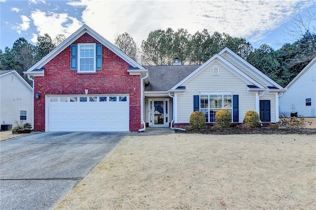 traditional home featuring concrete driveway, brick siding, and an attached garage