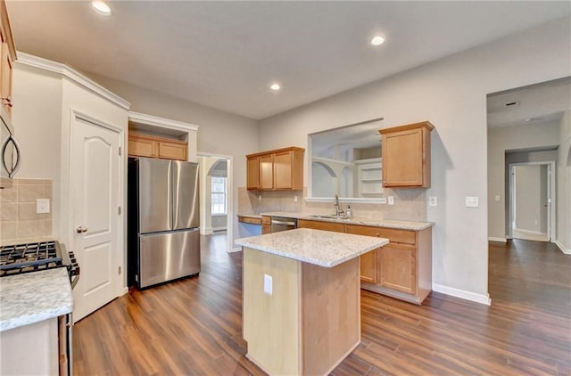 kitchen with tasteful backsplash, a kitchen island, light stone countertops, stainless steel appliances, and light brown cabinets