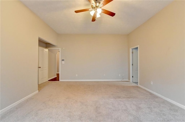 unfurnished room featuring light carpet, ceiling fan, and baseboards