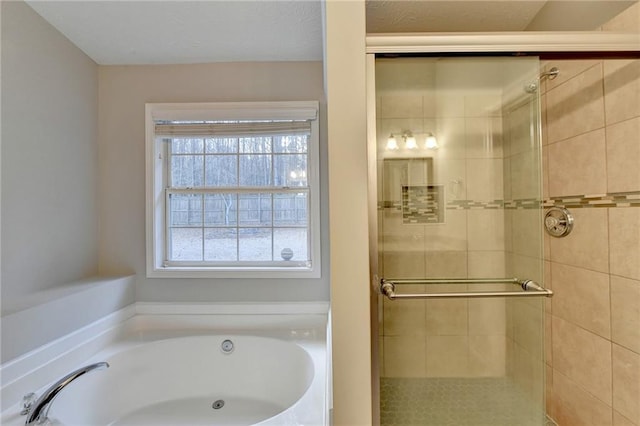 bathroom with a garden tub and a shower stall