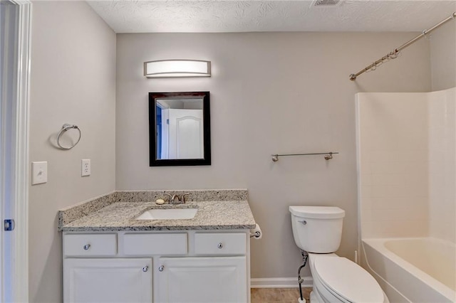 bathroom with baseboards, toilet, a textured ceiling, vanity, and shower / bathing tub combination