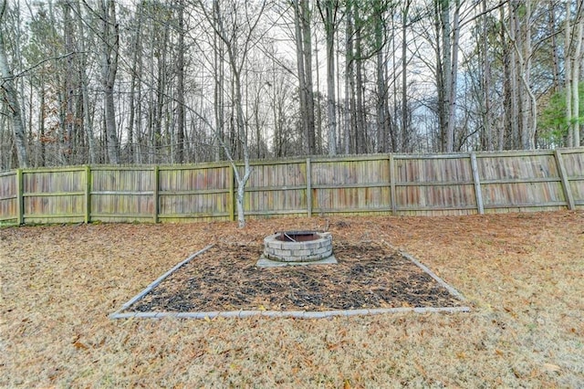 view of yard featuring an outdoor fire pit and a fenced backyard