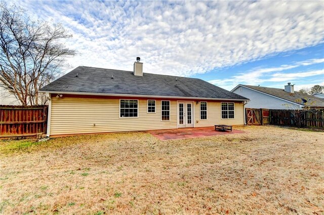 back of house featuring a patio area, a fenced backyard, and a yard