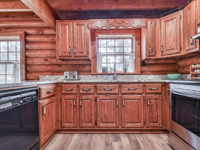 kitchen with light countertops, stainless steel range with electric cooktop, dishwasher, and log walls