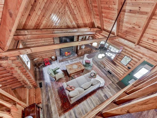 living room with wood ceiling, beam ceiling, rustic walls, and high vaulted ceiling