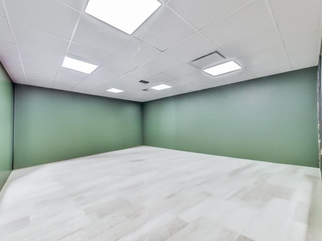empty room featuring a paneled ceiling and visible vents