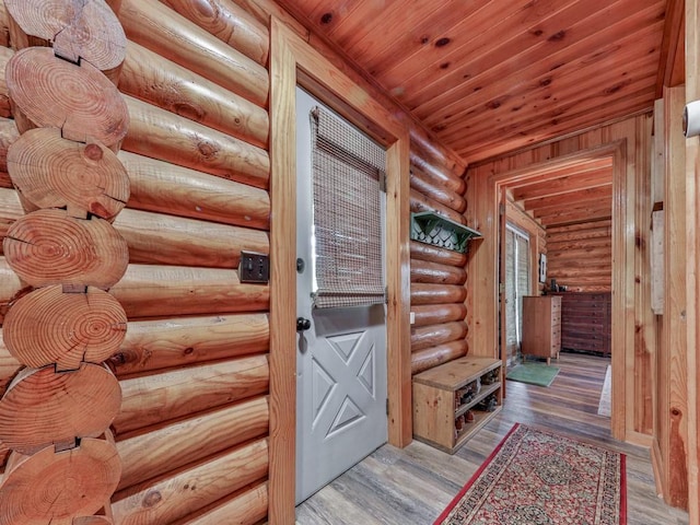 mudroom featuring wooden ceiling, rustic walls, and wood finished floors